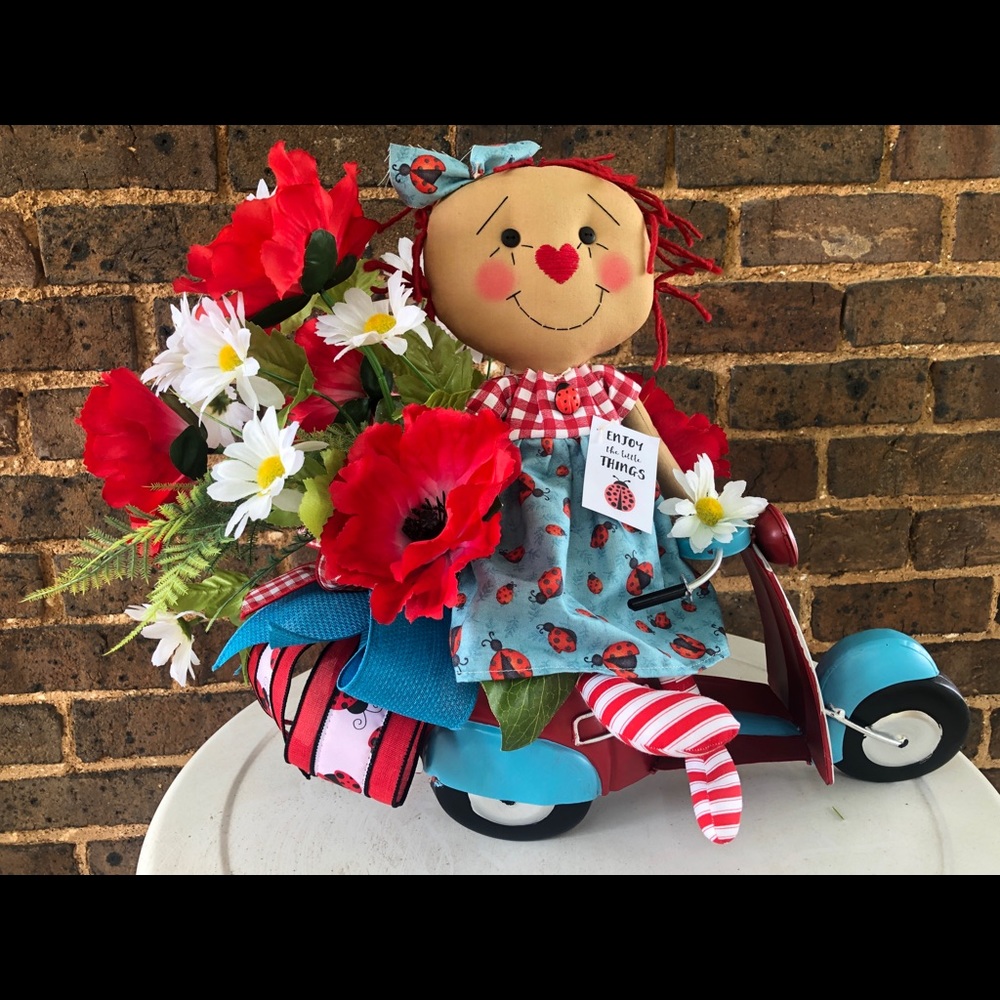 Handmade Annie doll on a scooter centerpiece